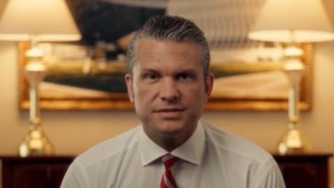Pete Hegseth is talking to the camera.