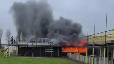 St Athan Primary School on fire. Thick black smoke and flames are coming from the building