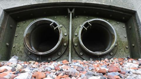 The Paul's Pier Combined Sewer Overflow (CSO) pipes are visible at low tide on the banks of the River Thames, as Britain's government is expected to set out measures to fix its broken water sector with Thames Water on the brink of failure, in London