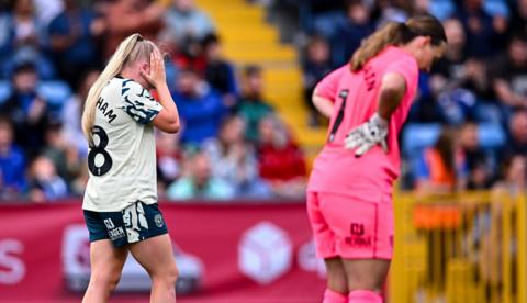 Cardiff City players Lily Billingham and goalkeeper Ceryn Chamberlain look on in dejection 