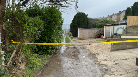 A police cordon closing off a muddy track near Dransfield Way in Bath