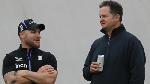 Brendon McCullum left, talks to Rob Key who is holding a drink