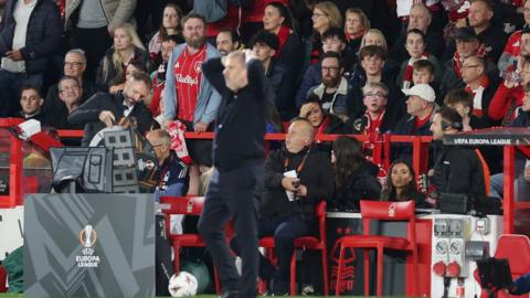 Ange Postecoglou, looks on as a Forest fan shouts at him during the UEFA Europa League match between Nottingham Forest FC and FC Midtjylland