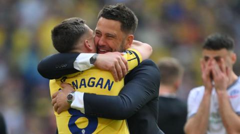 Oxford United's manager Des Buckingham with Cameron Brannagan after the full time whistle in the play-off final against Bolton Wanderers. 