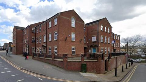 A relatively modern, brick-built office block on the corner of a street in Preston. 