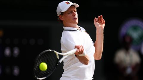 Jannik Sinner hits a forehand