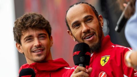 Ferrari drivers Charles Leclerc and Lewis Hamilton pictured holding microphones at the Sao Paulo Grand Prix