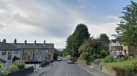 View of Buttershaw Lane with houses and cars in sight