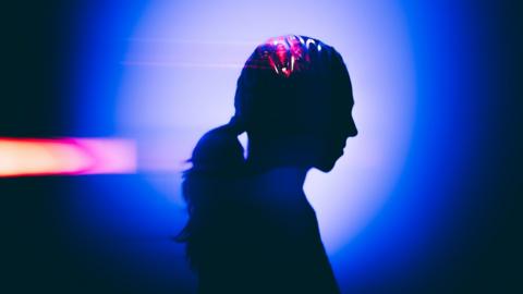 Profile headshot silhouette in vibrant abstract light