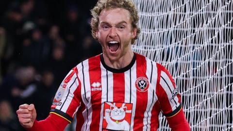 Tom Davies celebrates scoring