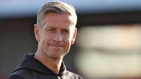 Newport County manager David Hughes applauds his team’s win at Accrington Stanley 