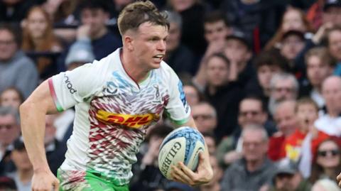 Jamie Benson runs with the ball for Harlequins