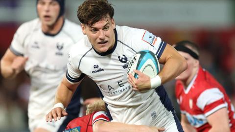 Tom Jordan in action for Bristol Bears, carrying the ball past an opponent