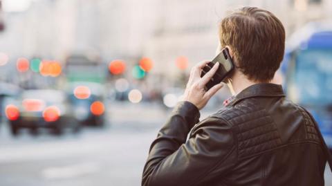 Man holding mobile phone to his ear 