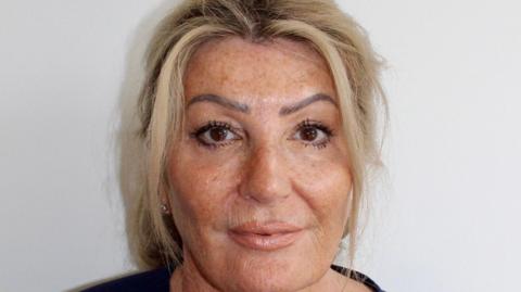 A close-up image of a woman, Barbara Pointon, who has blonde hair and is wearing a black top.