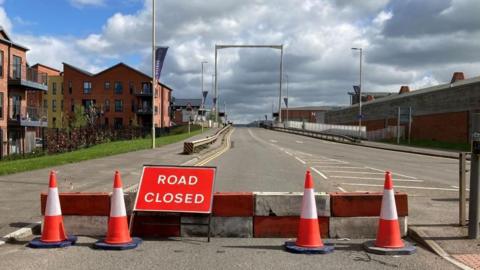 The High Orchard bridge in Gloucester with "road closed" signs and traffic cones in the foreground