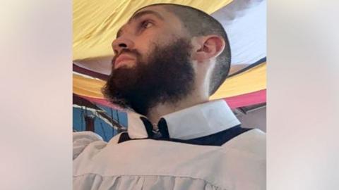 Justin Evans, a man with a black beard.