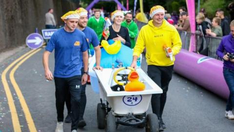 A bathtub on wheels ready to be used as a go-kart