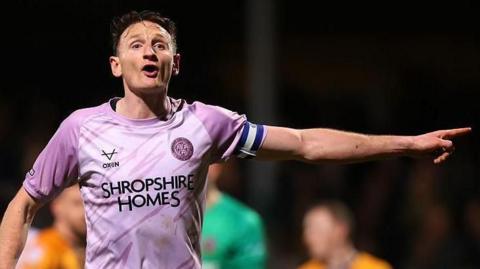 Shrewsbury Town defender Will Boyle shouts and points to team mates during a match