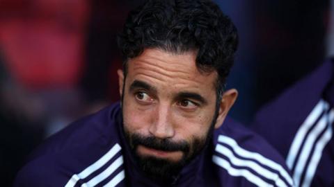 A picture of Ruben Amorim looking downcast on the bench during Manchester United's loss to Grimsby