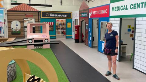 Rachael Parker stood inside the empty play area, which is modelled after a high street, complete with the supermarket, vet's clinic, medical centre, and café.
