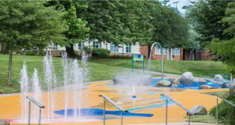 Yellow and blue splashpad with water fountains
