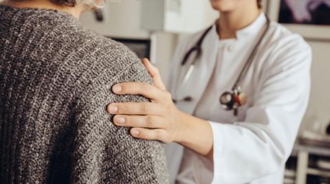 Stock photo of a doctor soothing patient