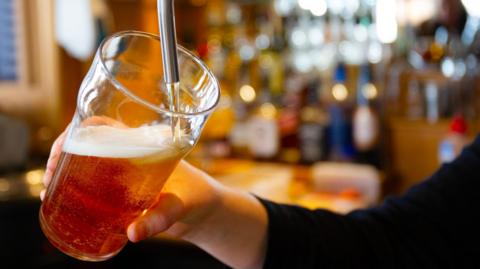 A beer is poured in a bar