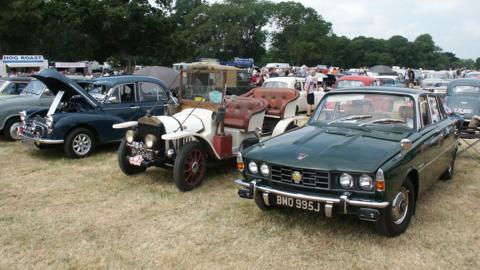 Classic cars in a field at Powderham Castle