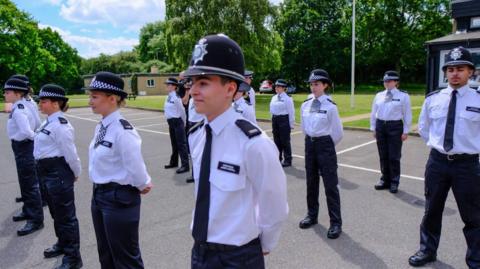 Police recruits standing in uniform