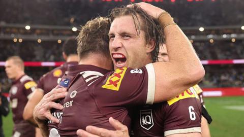 Cameron Munster and Harry Grant of the Maroons celebrate winning game two