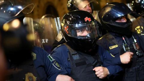 Police officers link arms as they keep watch over a demonstration near the alternate seat of the Mexican Senate, after protesters broke into the Senate building as a highly contested judicial reform proposal is debated, in the historic center of Mexico City, Mexico, September 10, 2024.