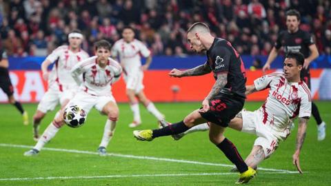 Bayer Leverkusen defender Alejandro Grimaldo strikes the crossbar