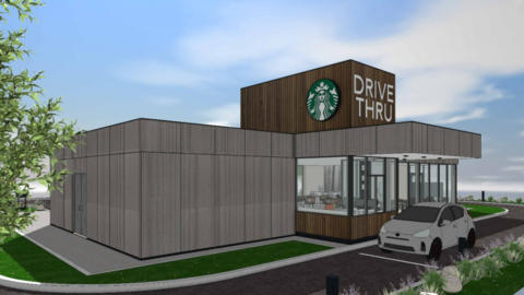 A computer-generated image of the proposed drive-thru, with a car shown next to the windows and a Starbucks logo on the building