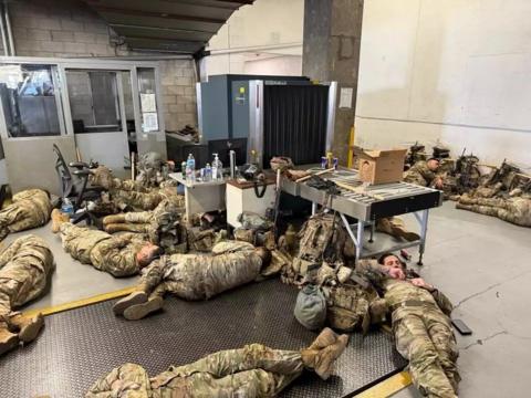 National Guard soldiers lie on the floor of an LA building following unrest