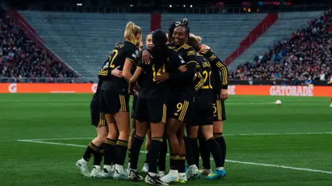 Malard celebrates with Manchester Utd team mates