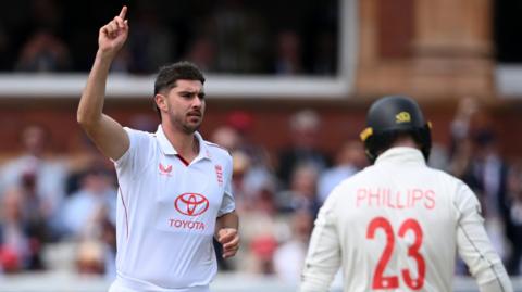 England fast bowler Josh Tongue (left) celebrates bowling New Zealand batter Glenn Phillips (right)