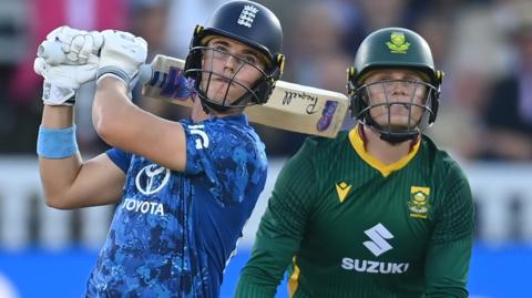 Jacob Bethell plays a shot while the South Africa wicketkeeper Ryan Rickelton watches on