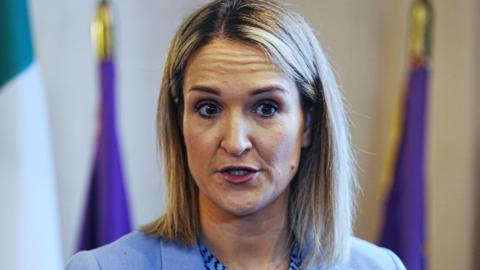 Helen McEntee, a woman with blonde hair, wearing a blue jacket.