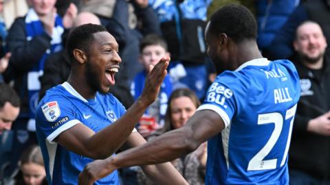 Ebou Adams celebrates with Millenic Alli after Portsmouth go 3-0 up against West Brom