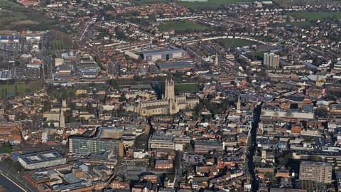 An aerial view of Gloucester showing the cathedral and rows of housing