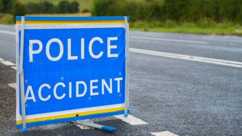 A blue police accident sign on a road, stock picture