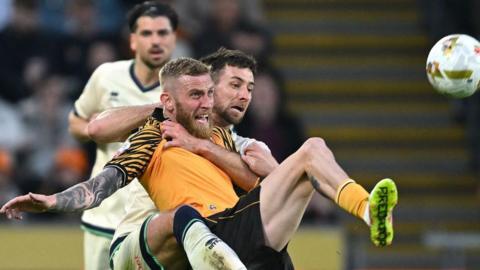 Ryan Leonard of Millwall and Oliver McBurnie of Hull City