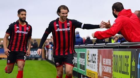 Footballer Tyler Harvey celebrating a goal for Truro City Football Club in the National League against Boston