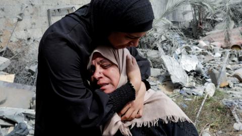 Naima, the grieving mother of Hala Zaarab, a Palestinian newlywed killed in an Israeli air strike, is comforted as she cries, in Khan Younis, southern Gaza, 3 May 2025