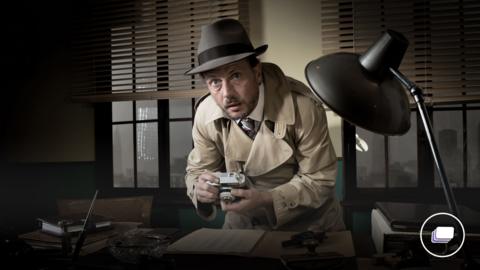 A picture of a spy agent caught stealing information in a hat, wearing a trench coat.