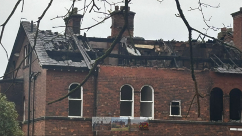 The partially collapsed roof and burnt out parts of the former red brick convent