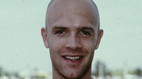 Curtis Robb in a photograph from earlier in his career. He has a shaved head