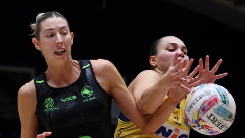 Jacqui Newton of Dragons challenges Leeds Rhino's Paige Reed