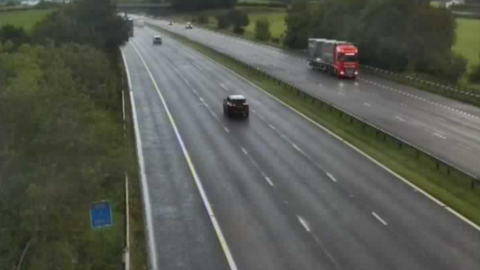 The M6 in Lancashire between junctions 35 at Carnforth and 36 Milton in Cumbria showing just a handful of vehicles due to the closure of part of the motorway at the previous junction. It is raining.